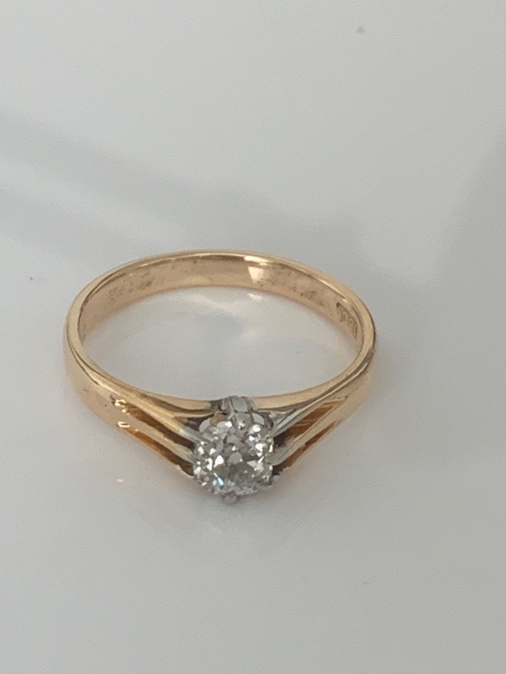 An Edwardian yellow gold solitaire ring featuring a single old mine cut diamond held in a multi-claw setting. View II