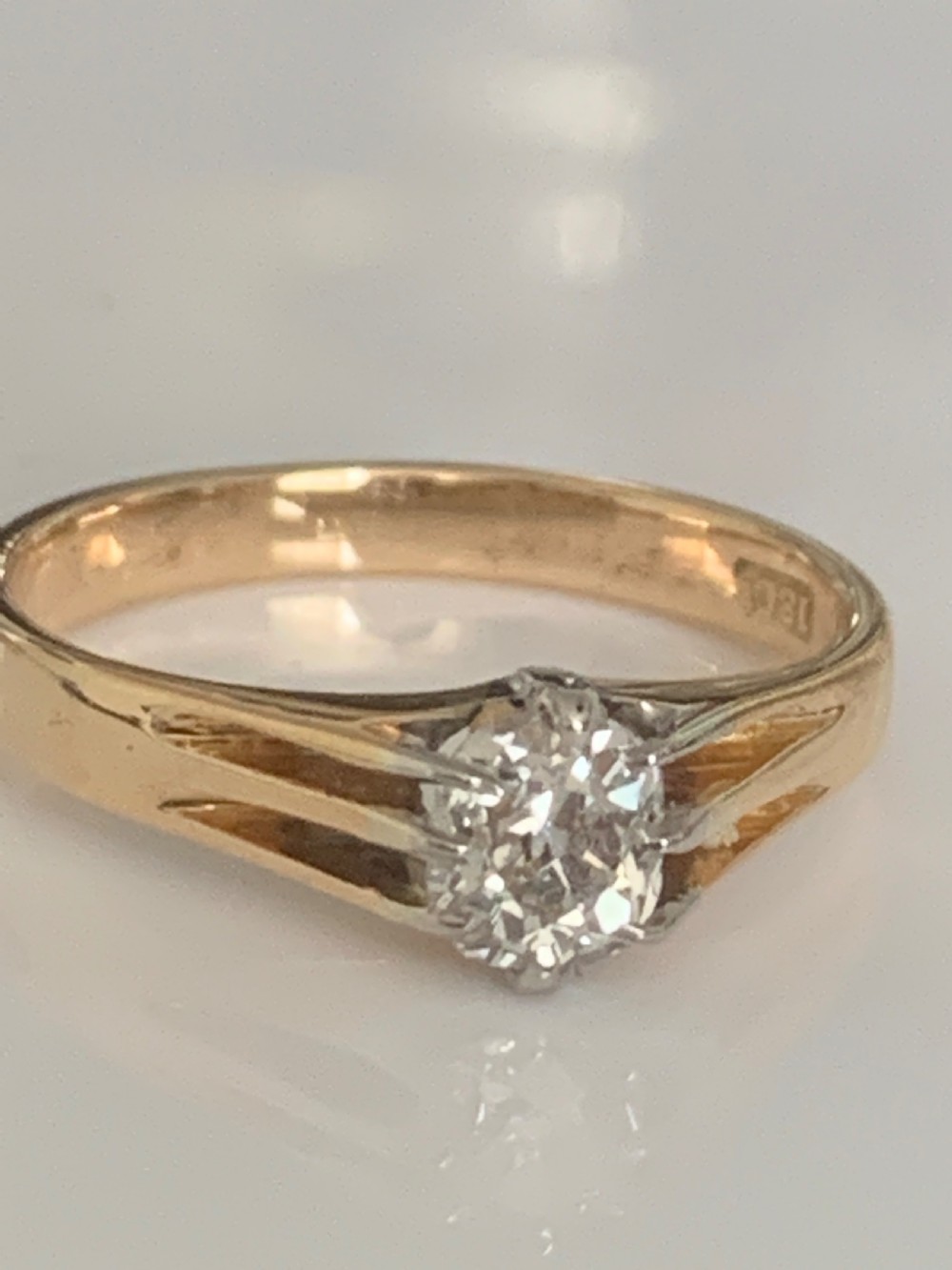 An Edwardian yellow gold solitaire ring featuring a single old mine cut diamond held in a multi-claw setting. View III