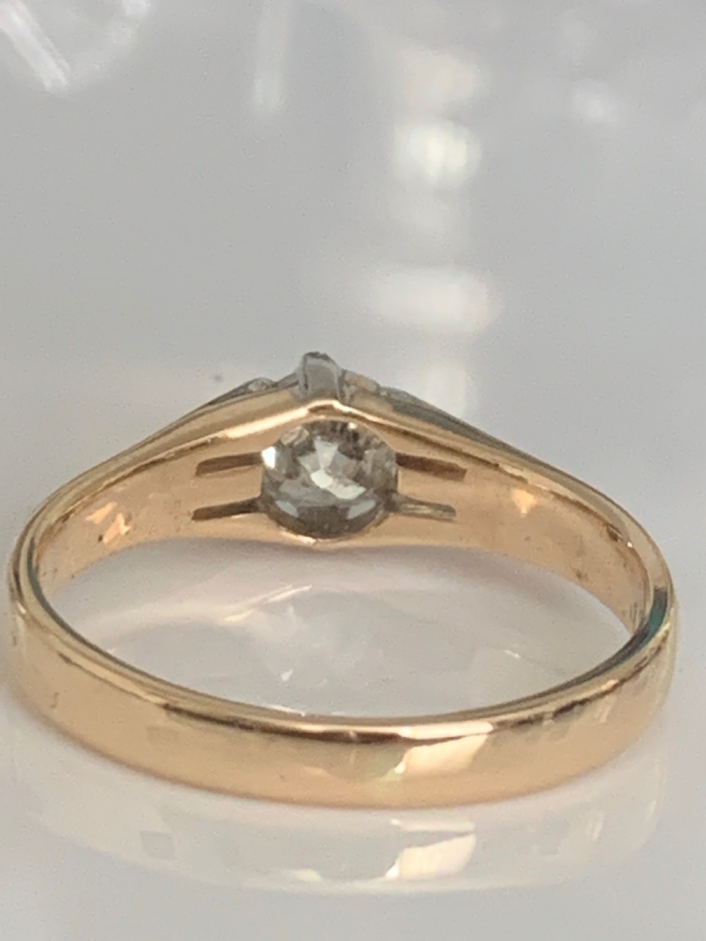 An Edwardian yellow gold solitaire ring featuring a single old mine cut diamond held in a multi-claw setting. View V