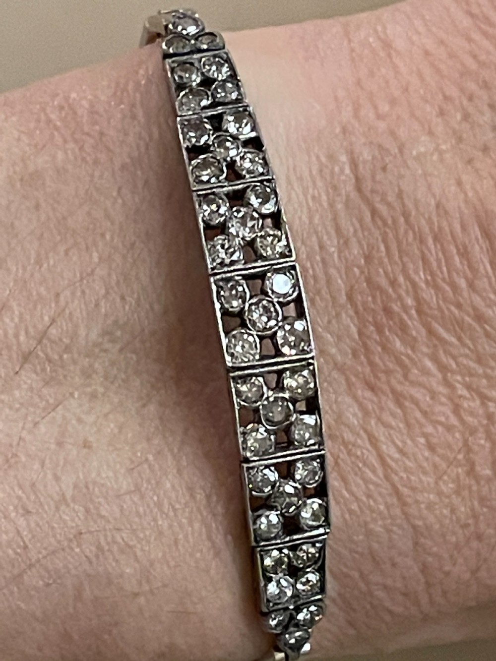 An Edwardian circa 1910 articulated bracelet set with multiple diamonds across geometric rectangular panels. View IV