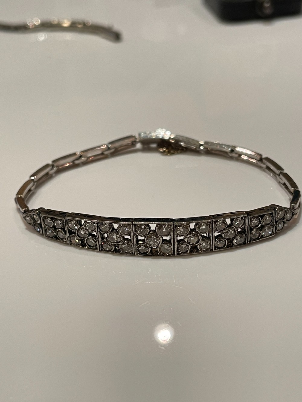 An Edwardian circa 1910 articulated bracelet set with multiple diamonds across geometric rectangular panels. View VI