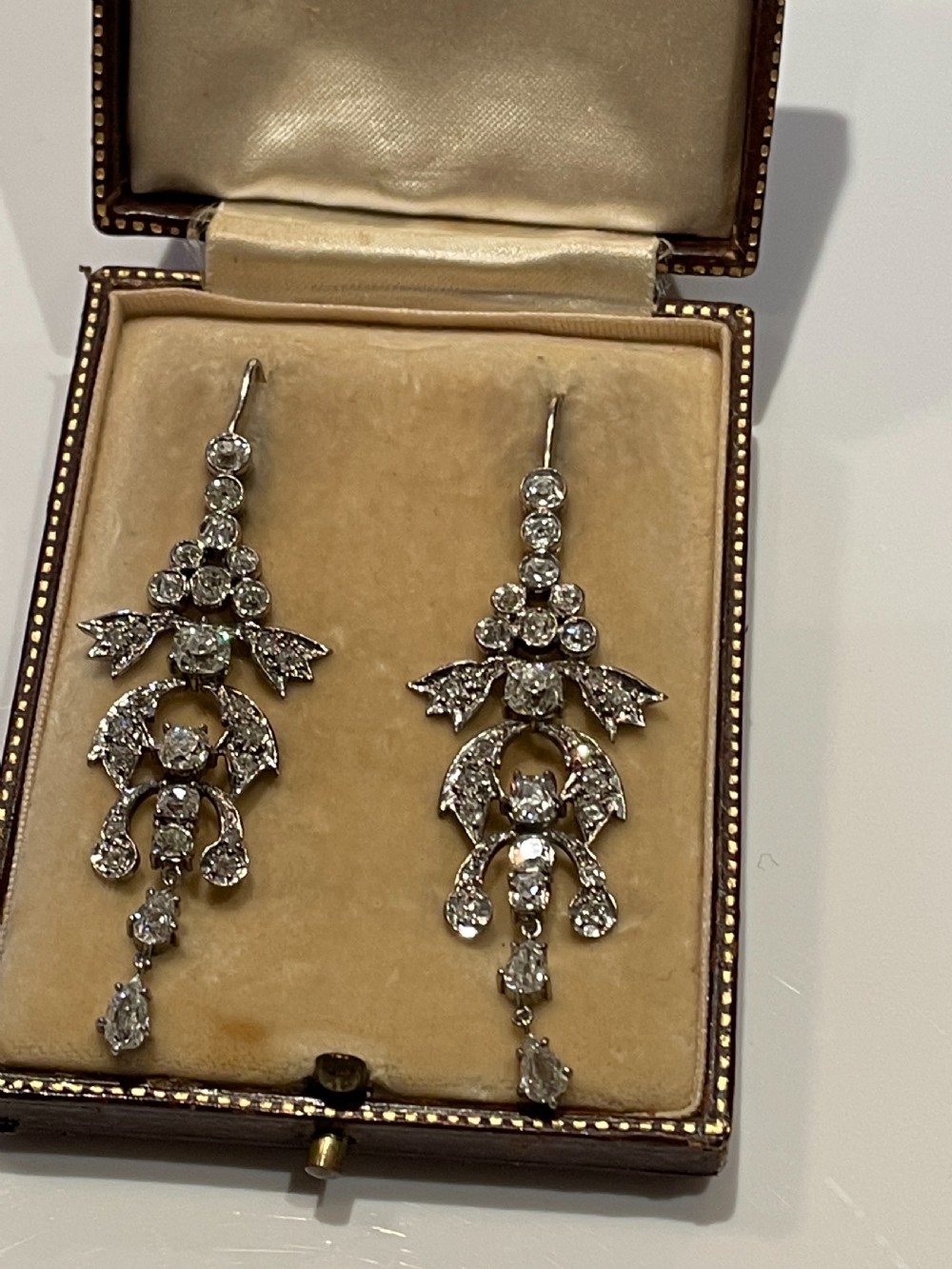 Pair of early 20th-century articulated drop earrings set with old European cut diamonds in an intricate garland framework. View III