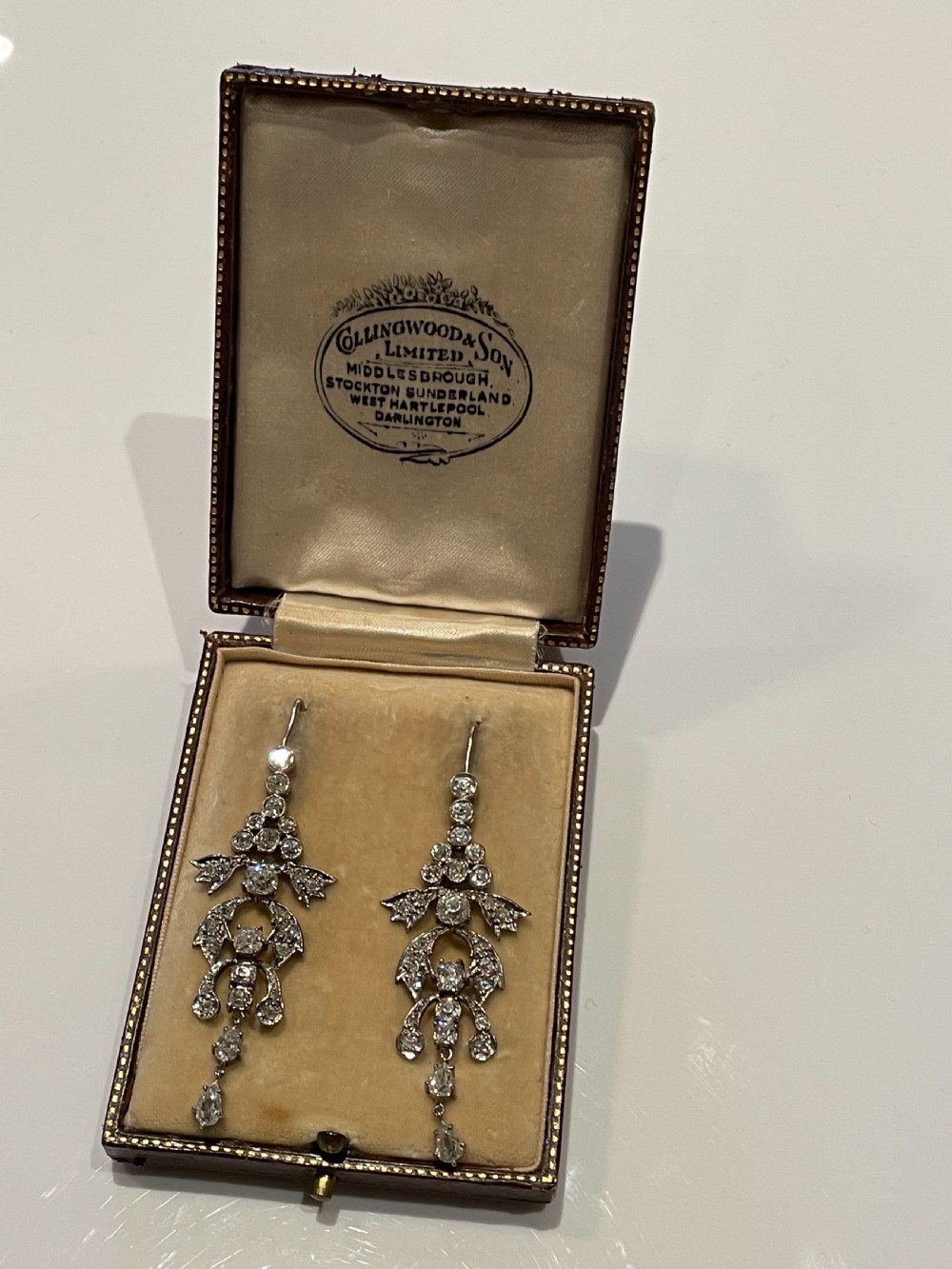 Pair of early 20th-century articulated drop earrings set with old European cut diamonds in an intricate garland framework. View IV