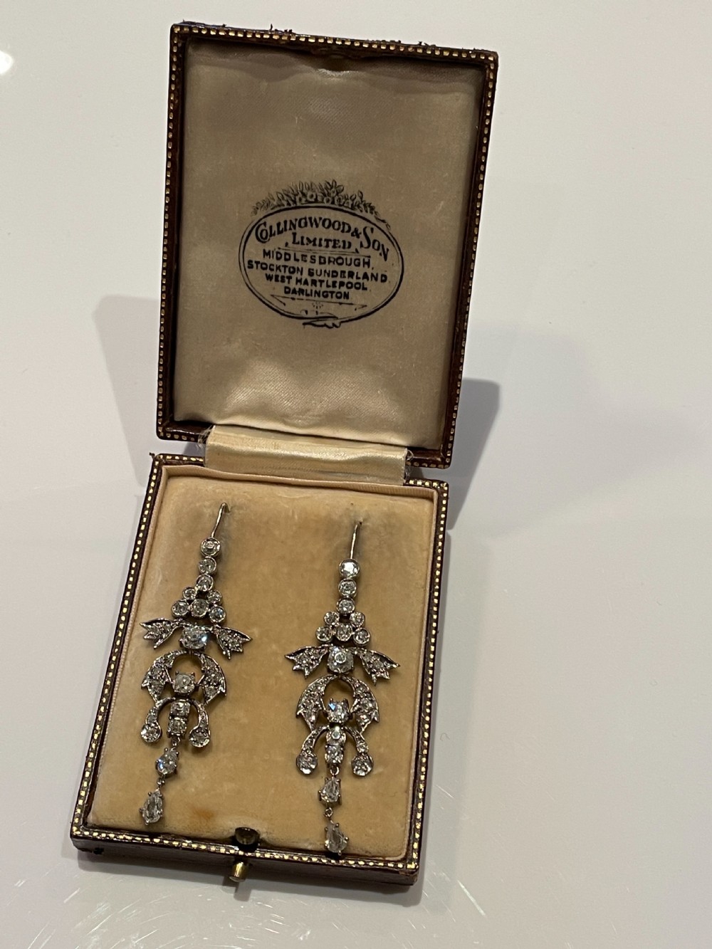 Pair of early 20th-century articulated drop earrings set with old European cut diamonds in an intricate garland framework. View V