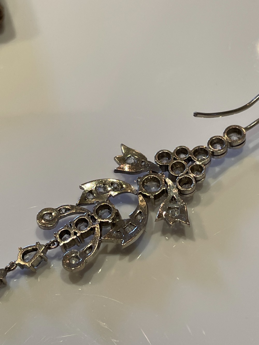 Pair of early 20th-century articulated drop earrings set with old European cut diamonds in an intricate garland framework. View VI