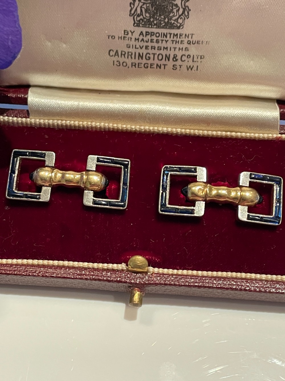 A pair of Art Deco style 18ct gold and sapphire geometric cufflinks presented in a velvet fitted box. View VI