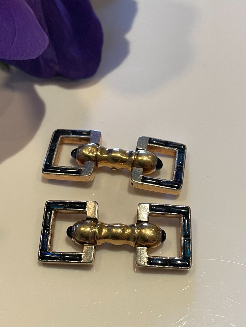 A pair of Art Deco style 18ct gold and sapphire geometric cufflinks presented in a velvet fitted box. View V
