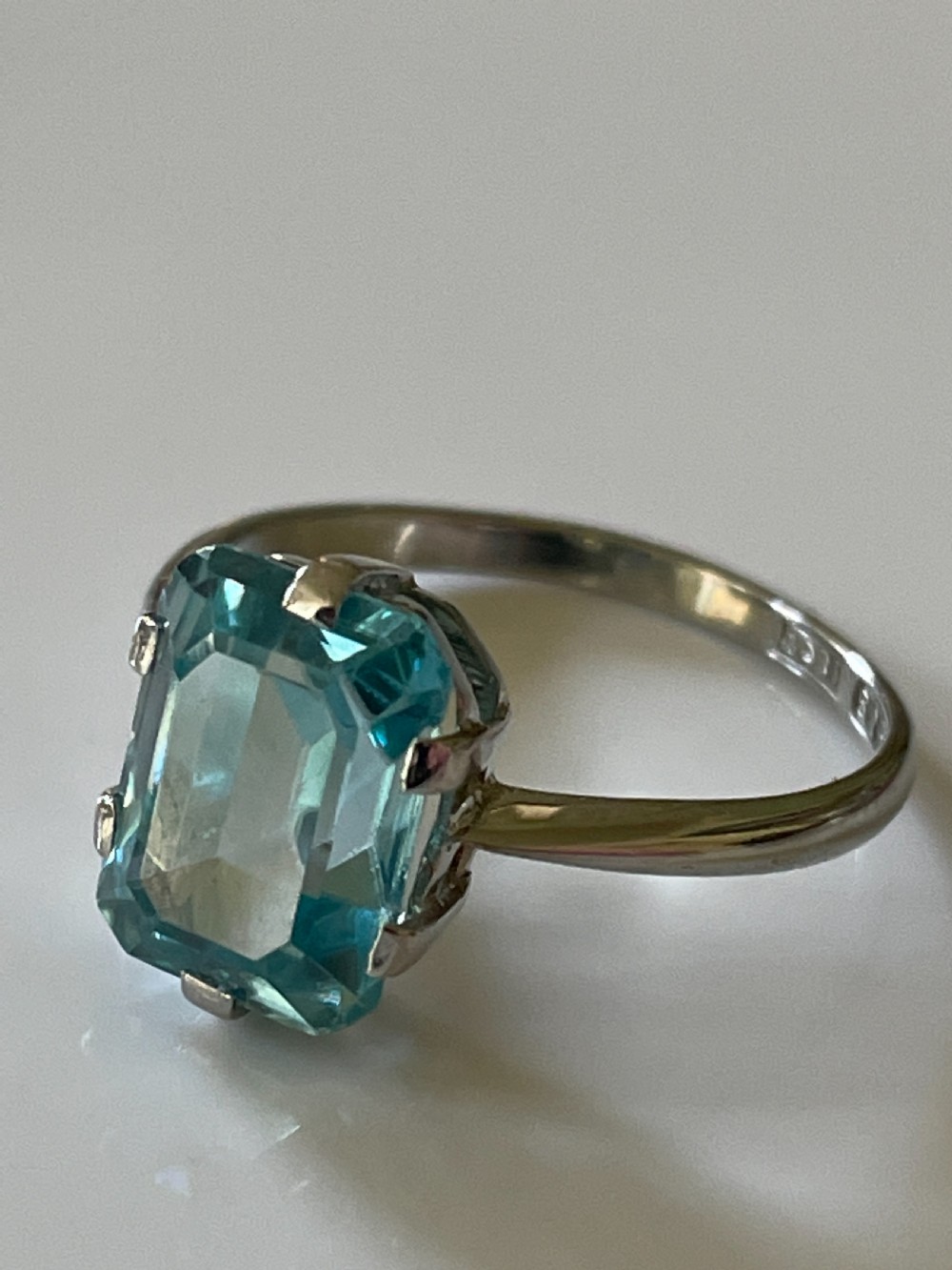 A mid-century white gold ring featuring a rectangular emerald-cut light blue zircon gemstone held in a claw setting.