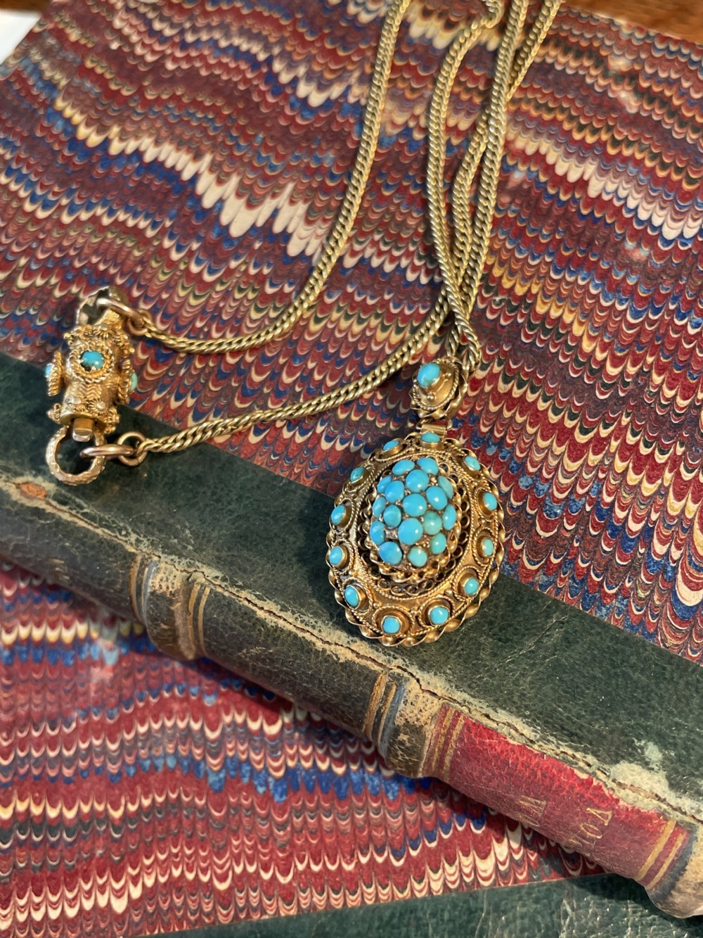 An early Victorian yellow gold chain featuring an oval pendant set with pave turquoise stones alongside a detailed matching turquoise clasp. View III