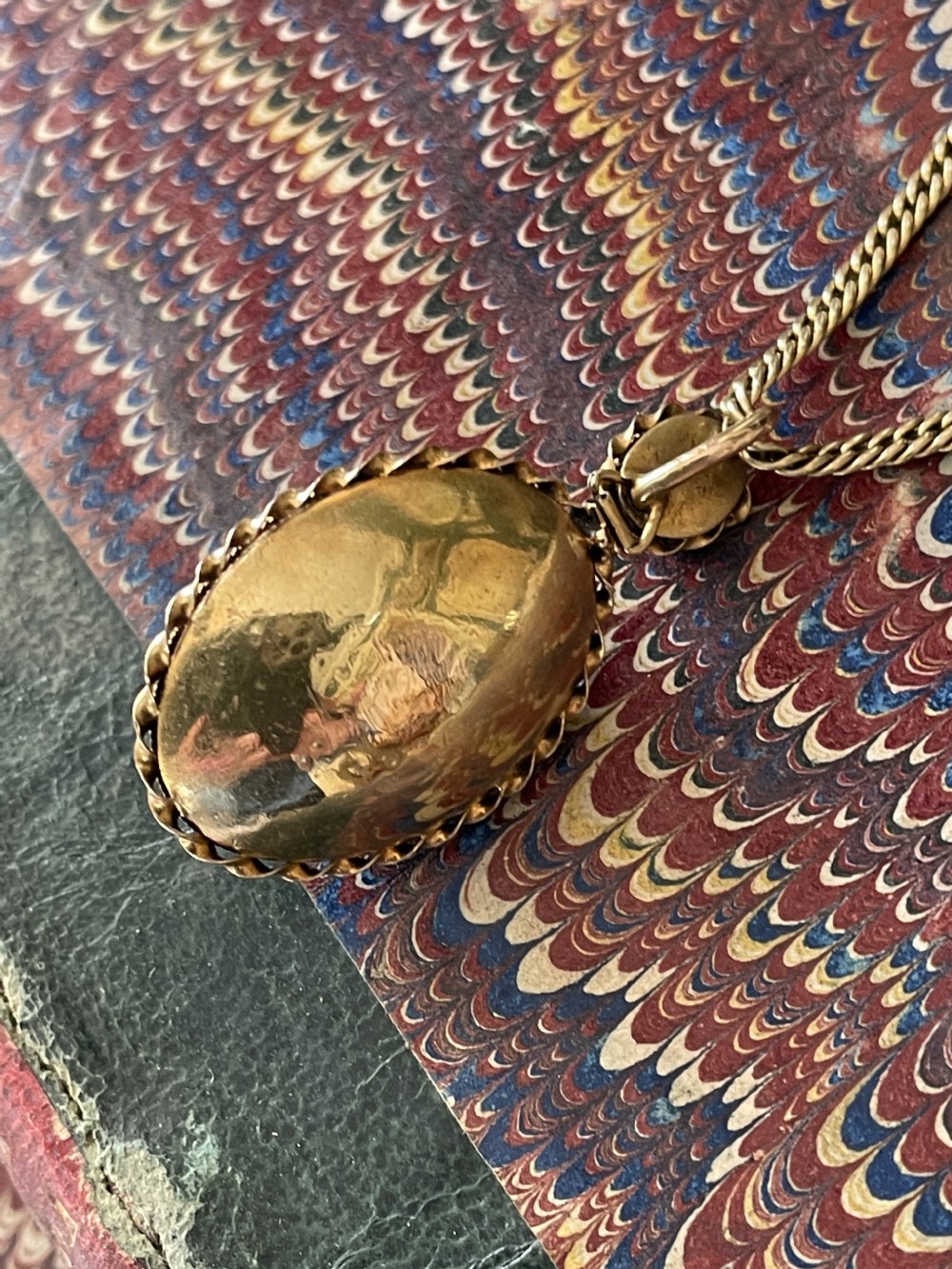 An early Victorian yellow gold chain featuring an oval pendant set with pave turquoise stones alongside a detailed matching turquoise clasp. View V