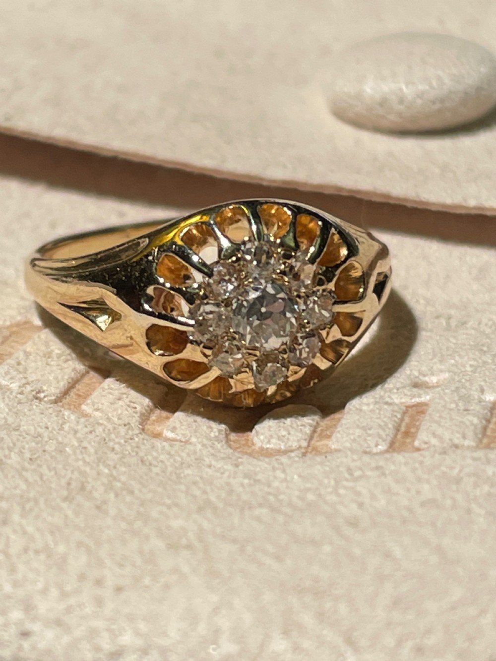 A Victorian yellow gold ring featuring a central cluster of old cut diamonds with carved detail along the shoulders. View II