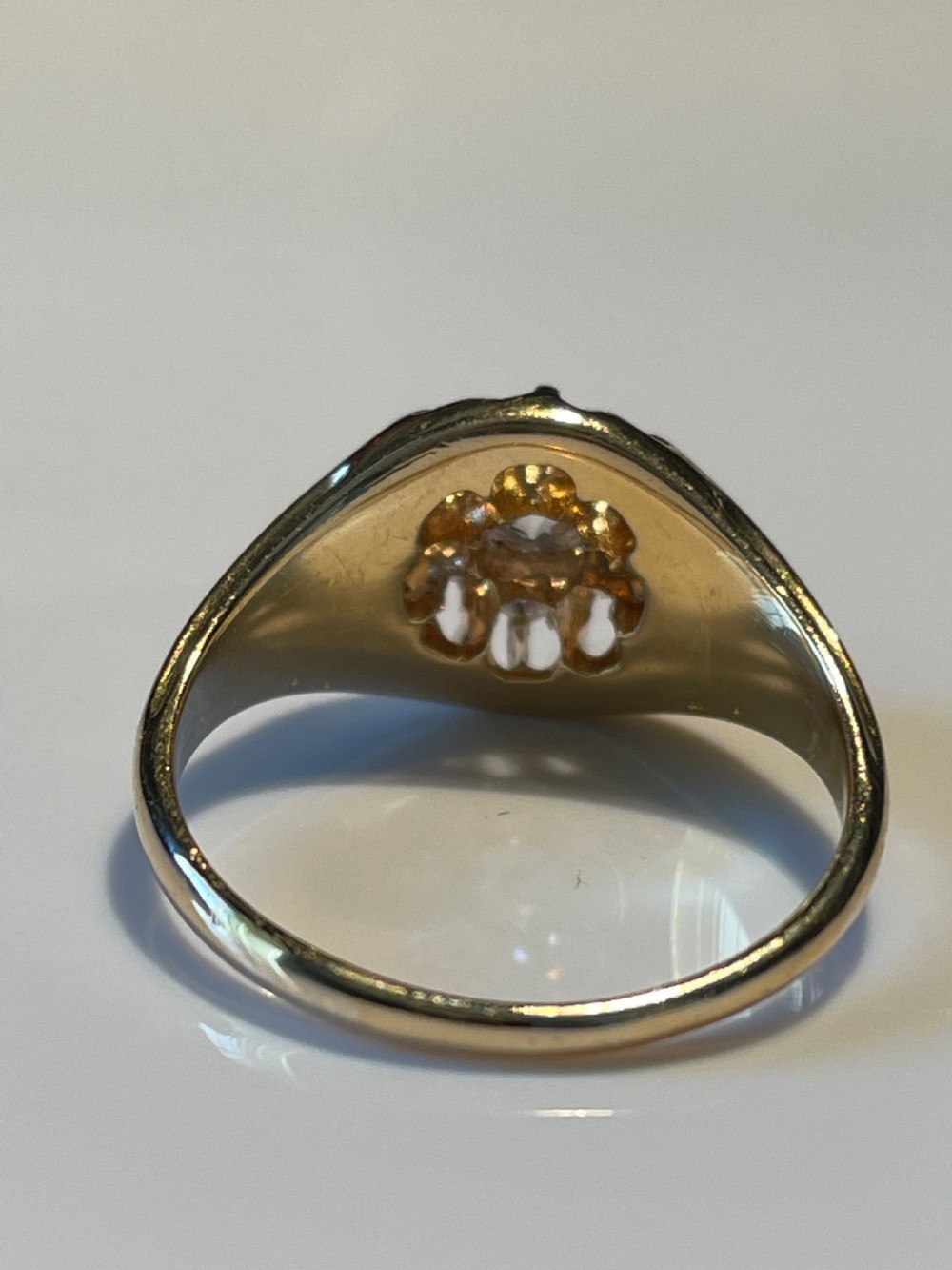 A Victorian yellow gold ring featuring a central cluster of old cut diamonds with carved detail along the shoulders. View III
