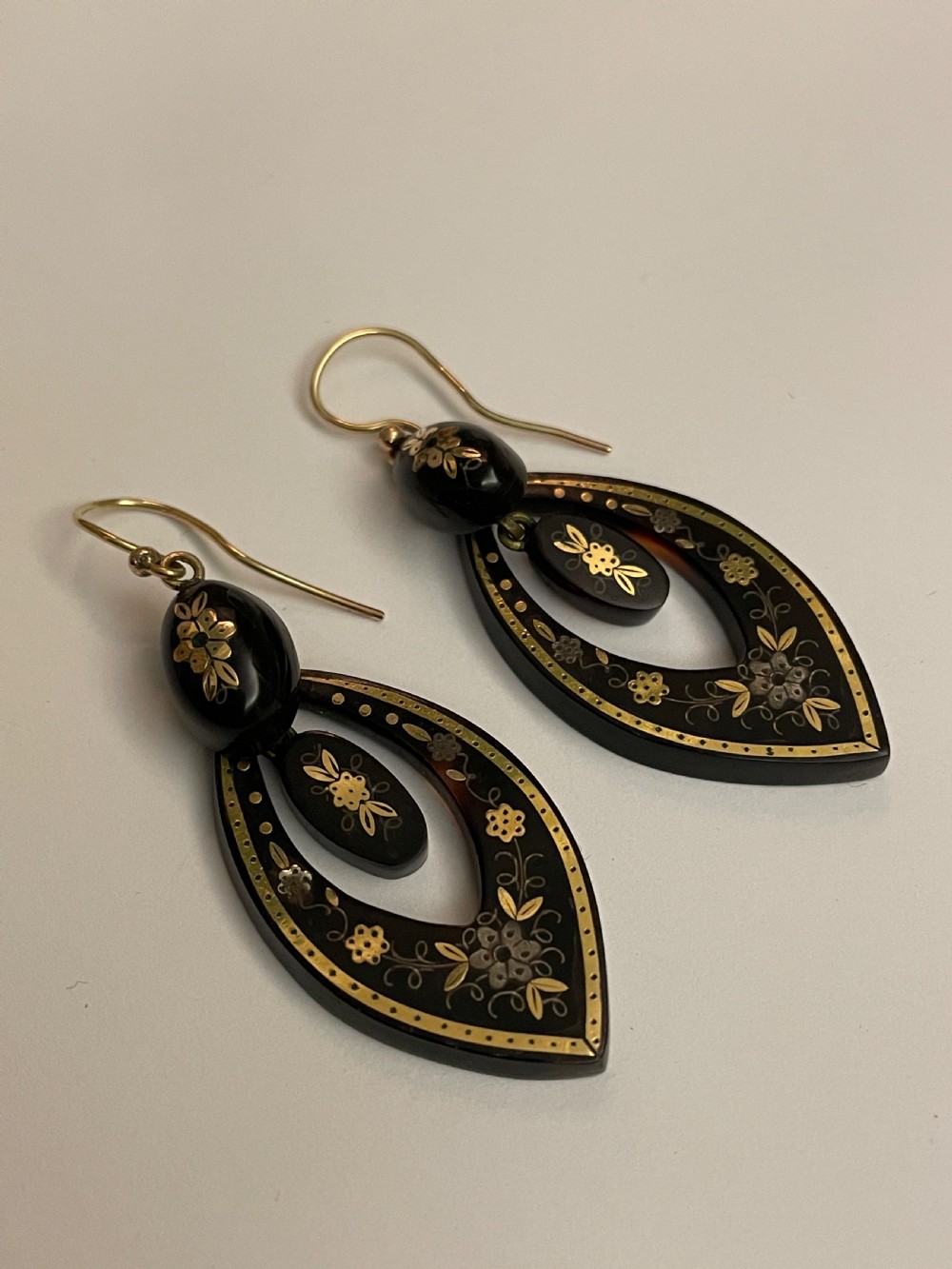 Pair of Victorian tortoiseshell drop earrings decorated with floral gold inlay work and fitted with gold ear wires. View II