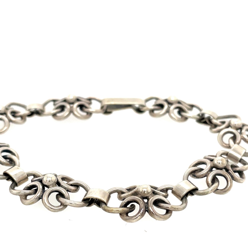 A vintage Swedish silver chain bracelet featuring coiled wirework loops connected by rectangular metal bars and sphere accents.