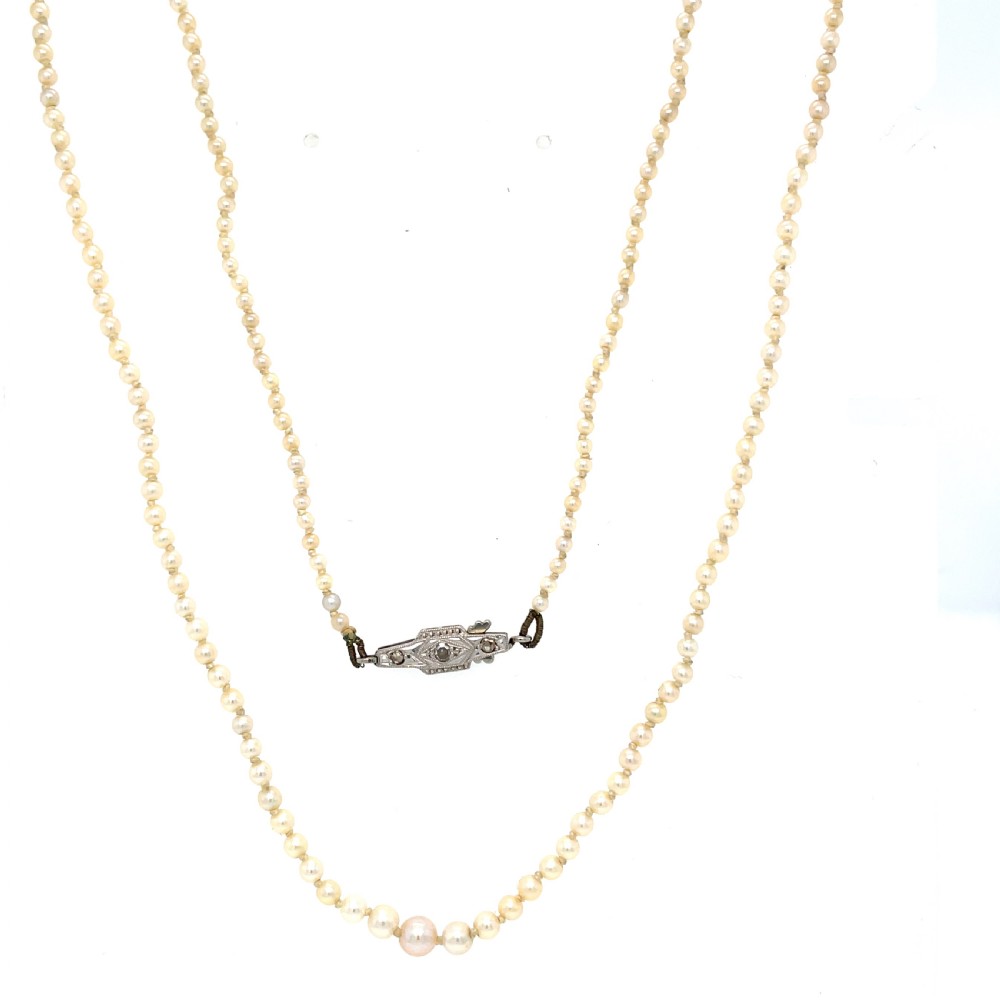 A single strand of natural saltwater pearls fitted with a geometric pierced metal clasp.
