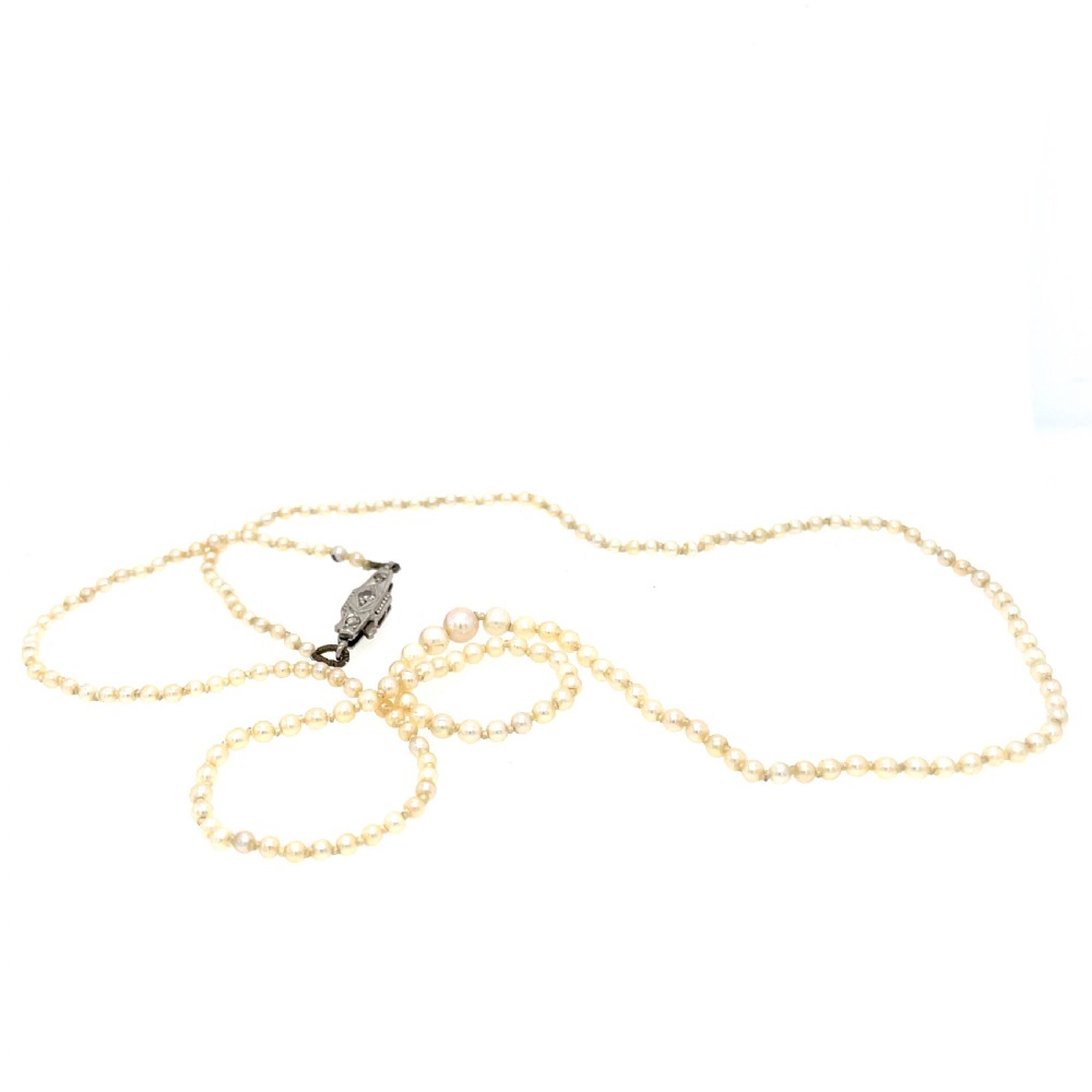 A single strand of natural saltwater pearls fitted with a geometric pierced metal clasp. View II