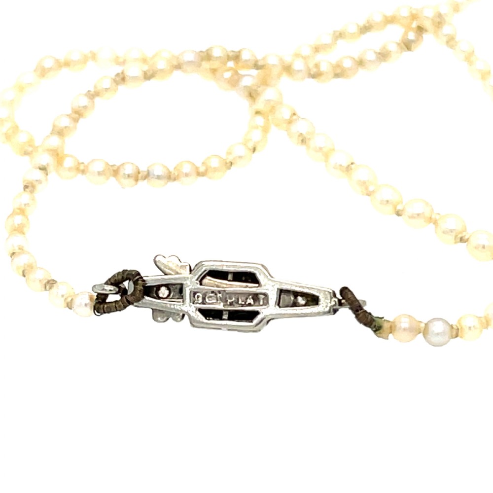 A single strand of natural saltwater pearls fitted with a geometric pierced metal clasp. View III