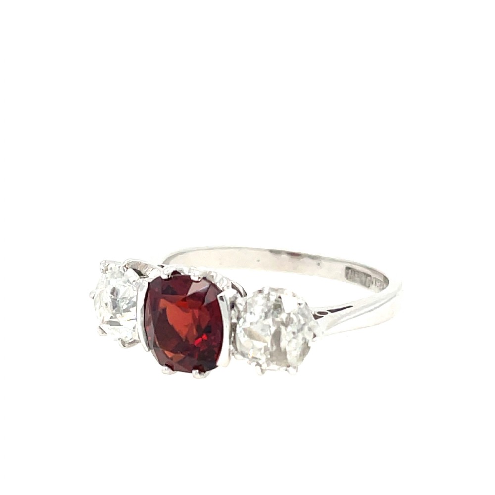 An antique platinum three-stone ring featuring a central cushion-cut red spinel flanked by two old cut diamonds. View III
