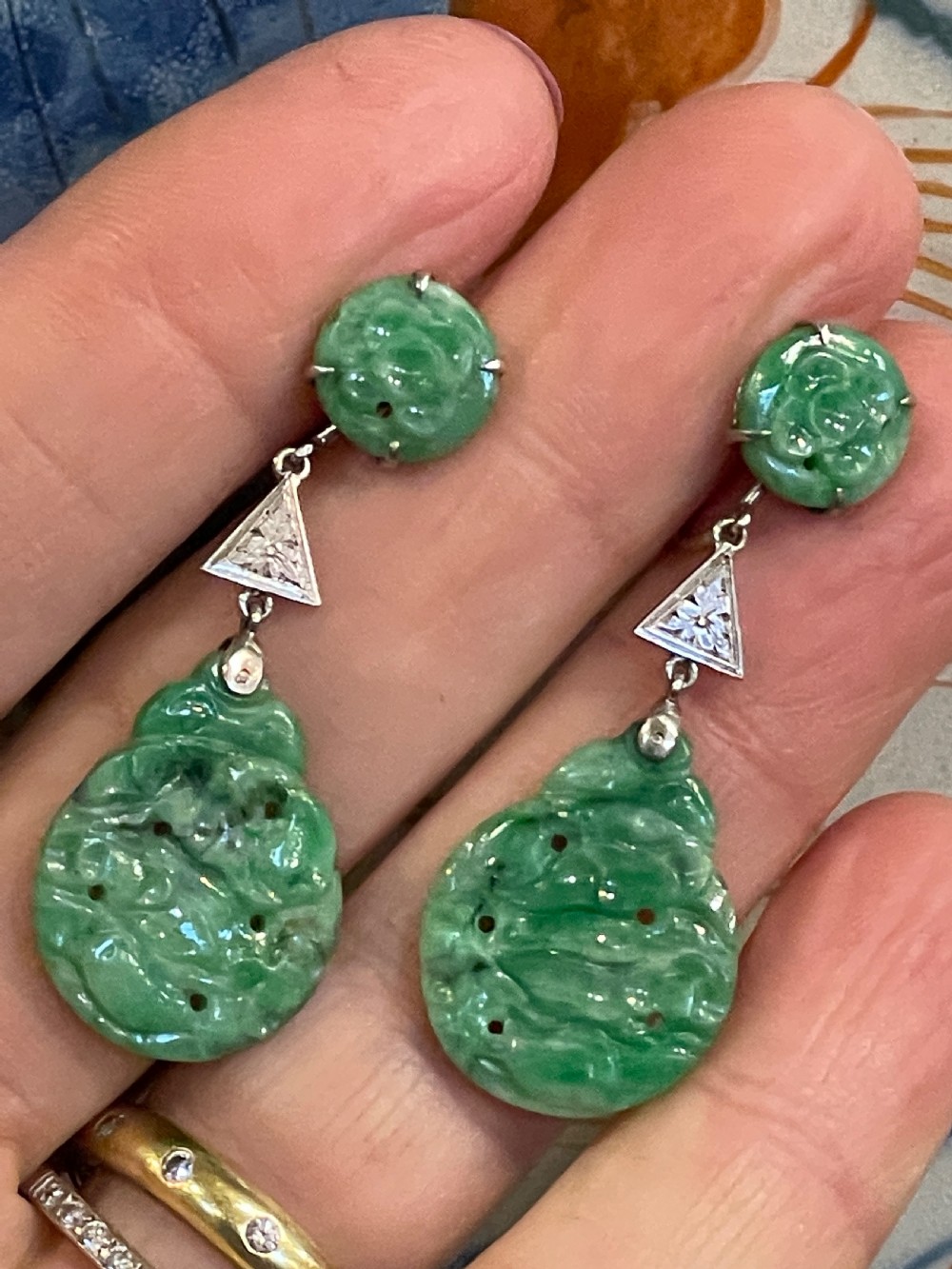 A pair of antique 9ct gold drop earrings featuring carved circular and teardrop green jadeite cabochons suspended from geometric triangular settings. View III