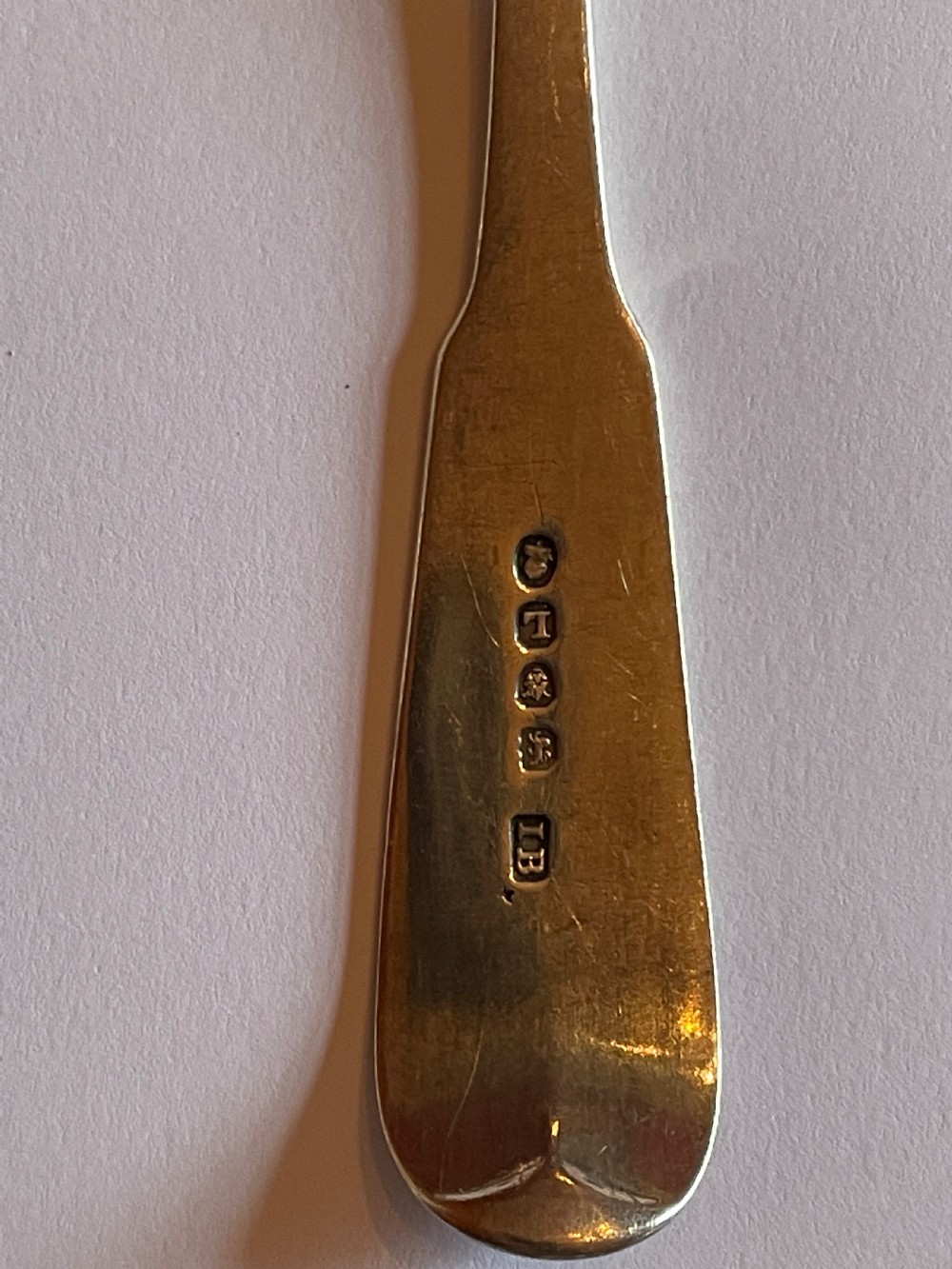 A pair of Georgian sterling silver serving spoons with smooth oval bowls and engraved monograms on the handles. View III