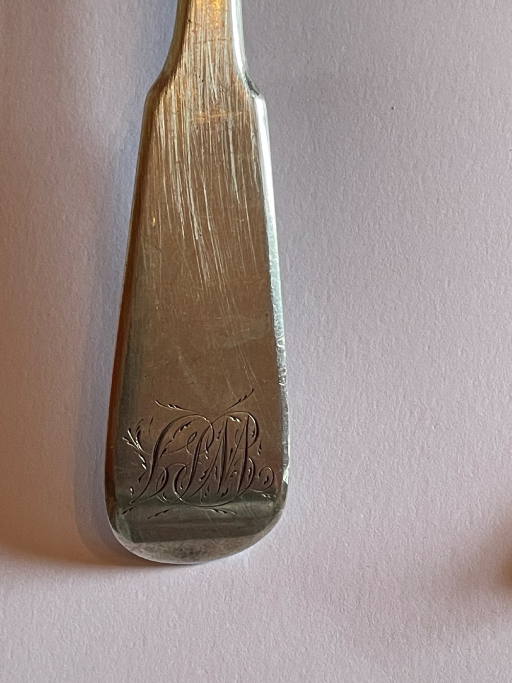 A pair of Georgian sterling silver serving spoons with smooth oval bowls and engraved monograms on the handles. View IV