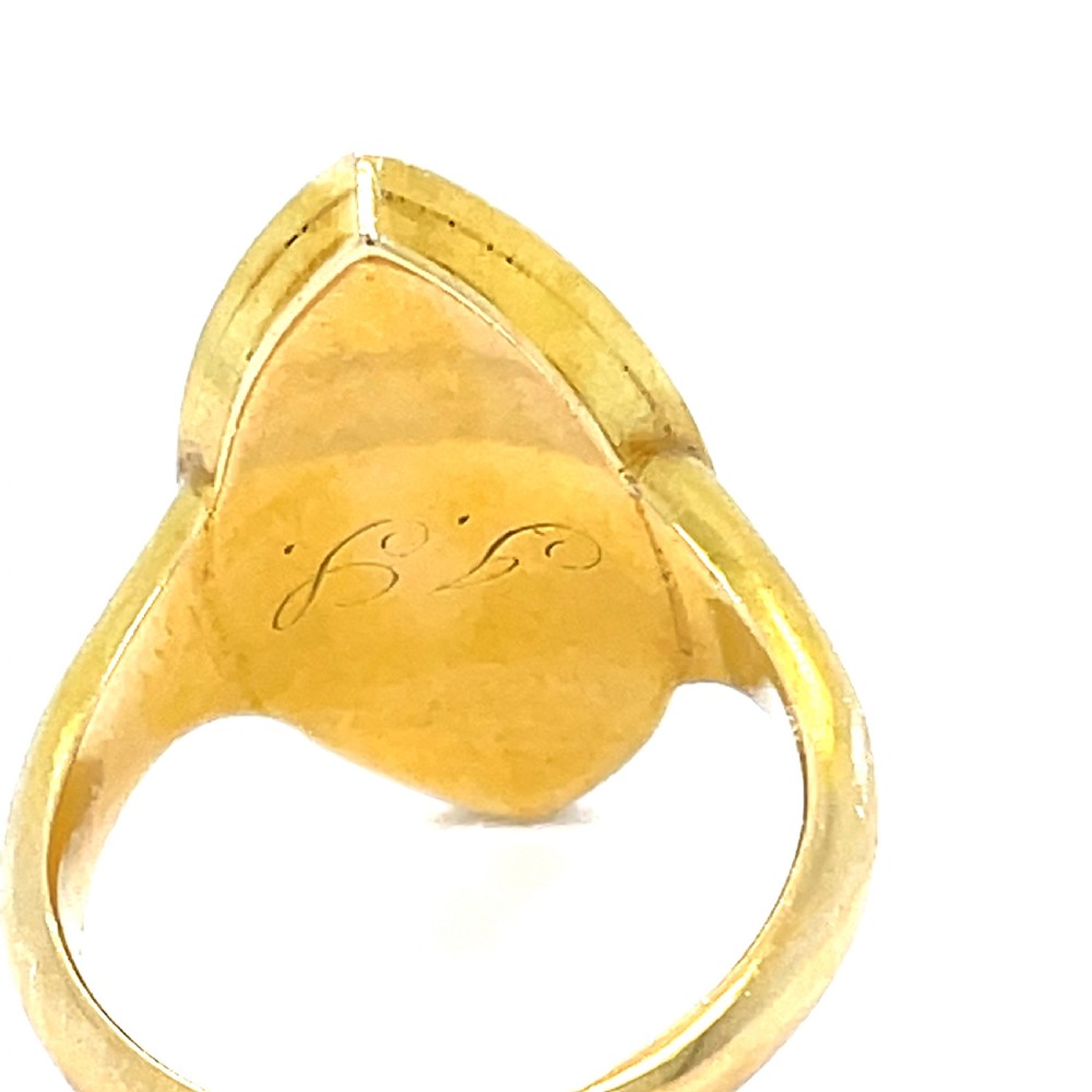 An early Victorian 18ct yellow gold navette-shaped mourning ring featuring a central star-set diamond surrounded by black enamel foliage and a split pearl halo. View III