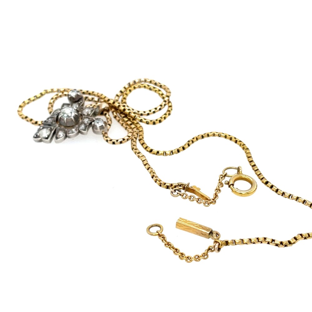 A Victorian silver-topped gold pendant set with diamonds in a scrollwork arrangement, suspended from a gold box chain. View III