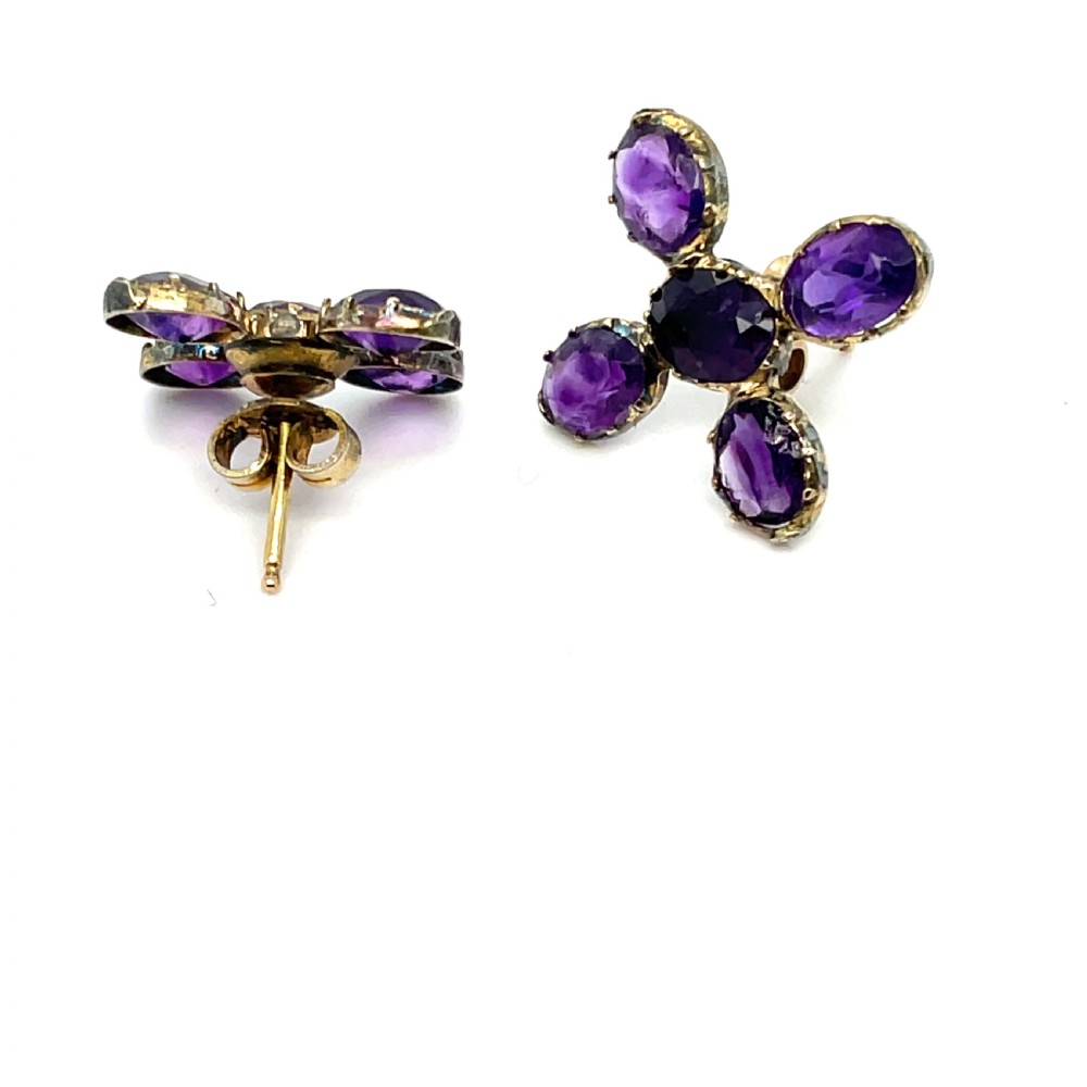 A pair of Georgian earrings featuring five oval, flat-cut purple amethysts set in a cross arrangement within crimped metal collets. View II