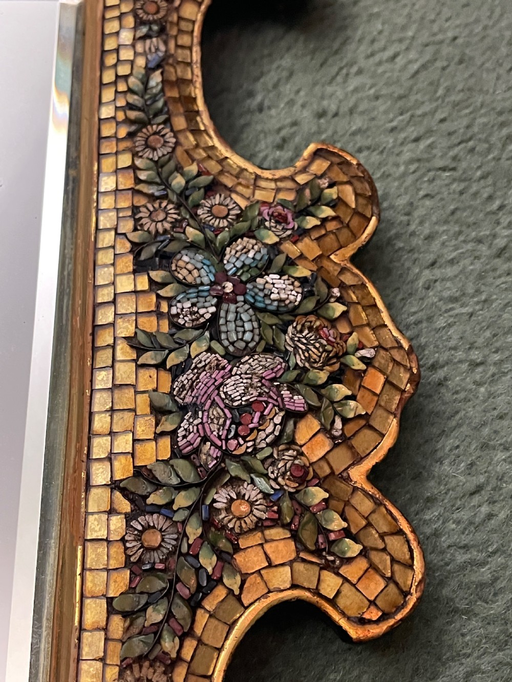 A 19th-century Italian micro mosaic wall mirror featuring a shaped gold tesserae frame decorated with colourful mosaic flowers around a rectangular mirror glass. View V