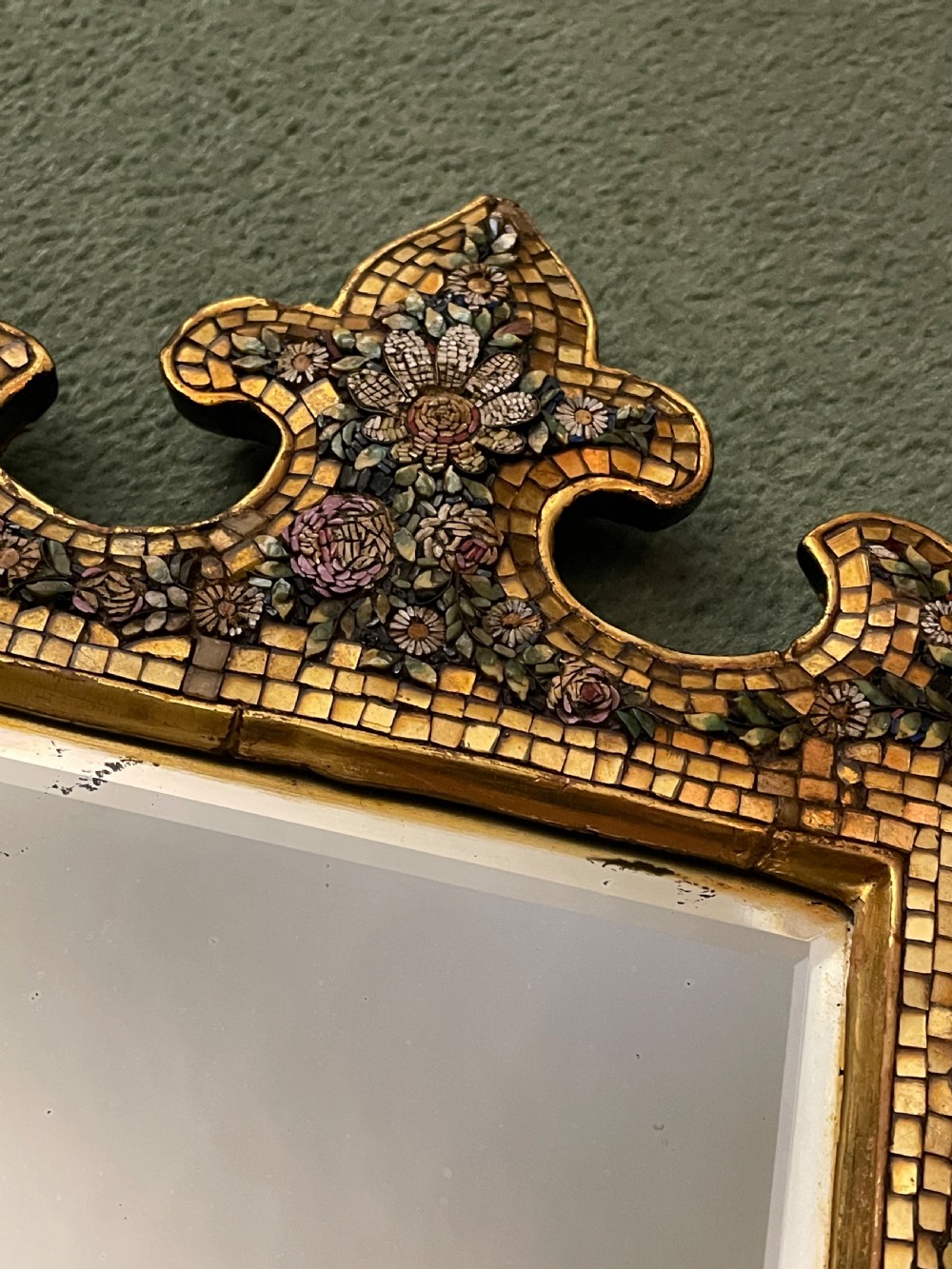 A 19th-century Italian micro mosaic wall mirror featuring a shaped gold tesserae frame decorated with colourful mosaic flowers around a rectangular mirror glass. View VI