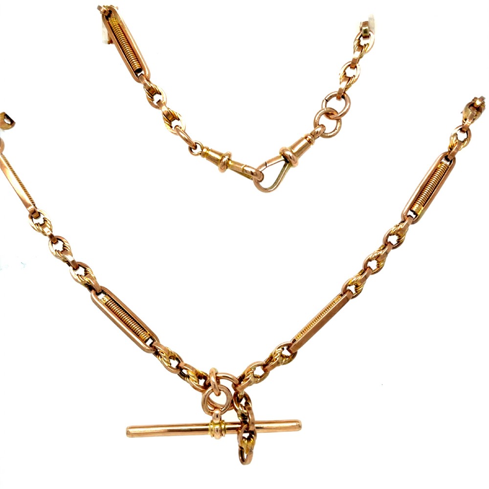 A Victorian 9ct rose gold watch chain featuring fancy bar links, twisted loop connectors, and a central hallmarked T-bar. View II