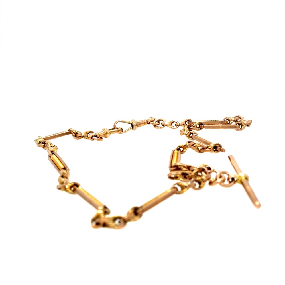 A Victorian 9ct rose gold watch chain featuring fancy bar links, twisted loop connectors, and a central hallmarked T-bar. View III