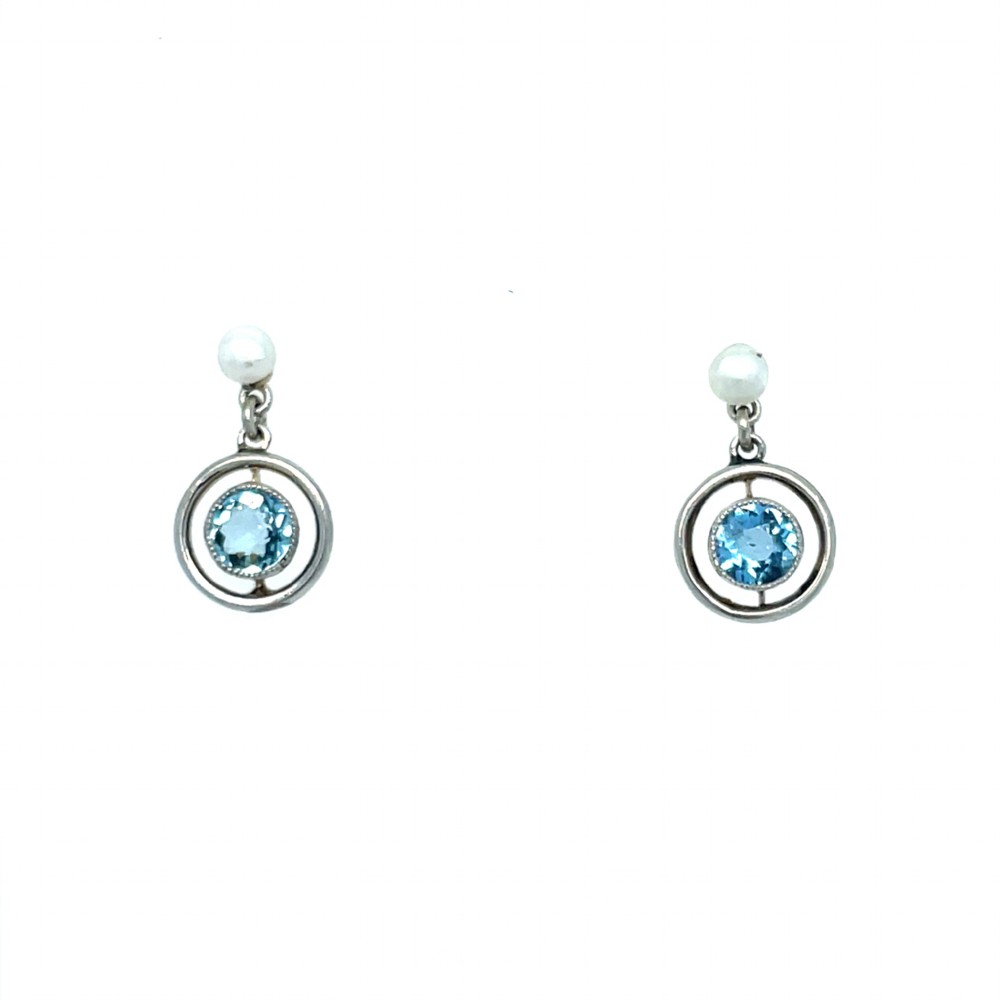 A pair of Edwardian drop earrings featuring round bezel-set aquamarine gemstones inside open circular mounts suspended from pearl studs.