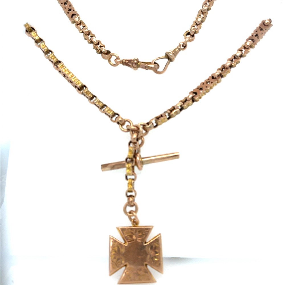 An antique 9ct rose gold Albert chain featuring textured links, a T-bar attachment, and an engraved cross-shaped fob pendant. View IV