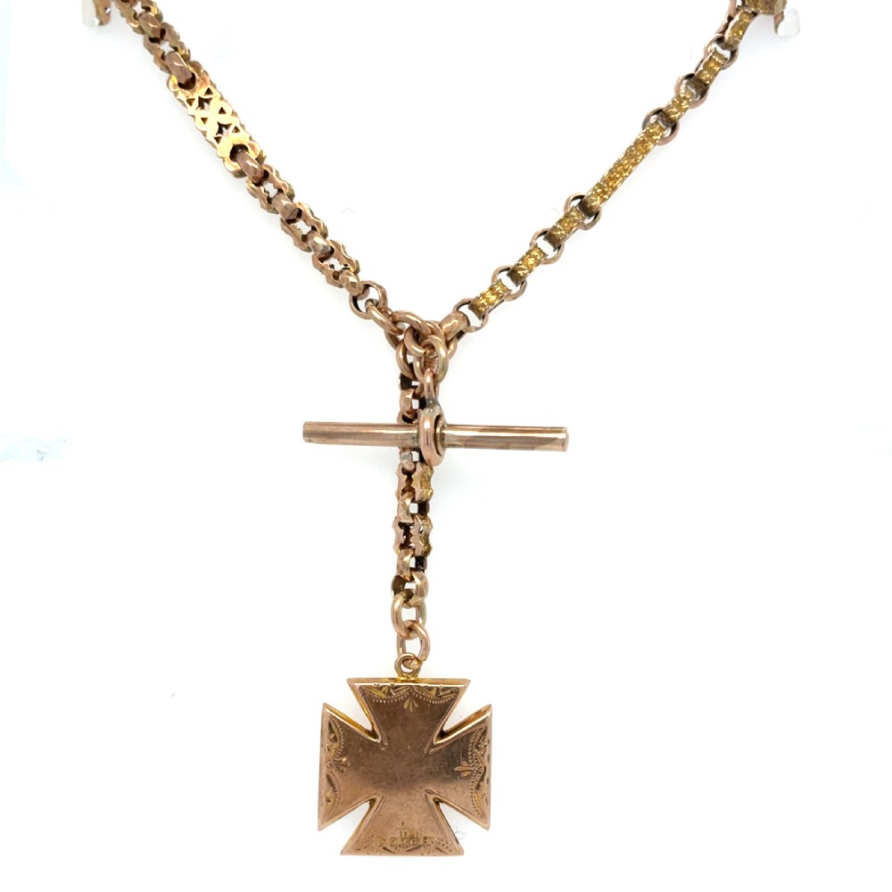 An antique 9ct rose gold Albert chain featuring textured links, a T-bar attachment, and an engraved cross-shaped fob pendant. View V