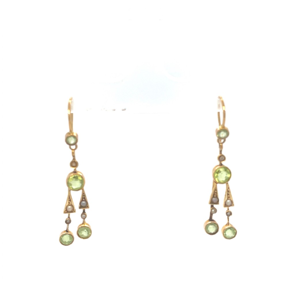 A pair of antique 15ct yellow gold drop earrings featuring collet-set green peridots and seed pearls on wire hooks.