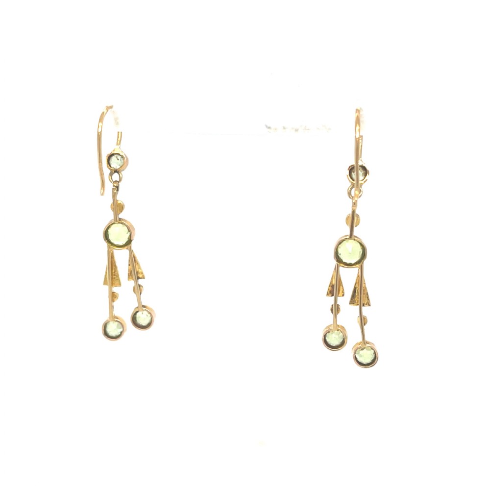 A pair of antique 15ct yellow gold drop earrings featuring collet-set green peridots and seed pearls on wire hooks. View II