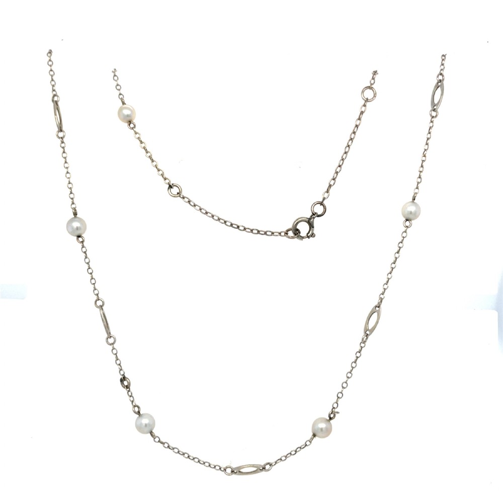 An antique 9ct white gold necklace featuring saltwater pearls spaced along a fine trace chain with elongated oval links. View II