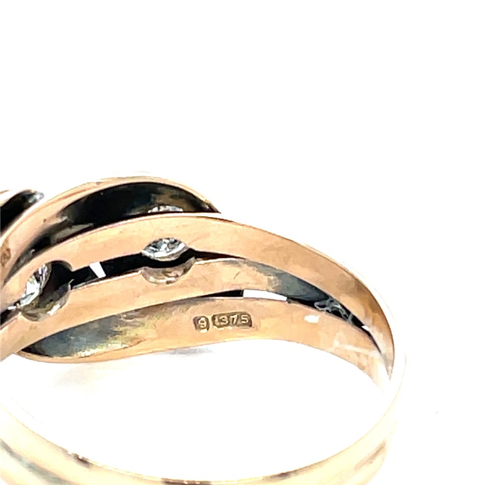 An antique yellow gold ring crafted with two entwined snake heads, each set with a round cut diamond. View II