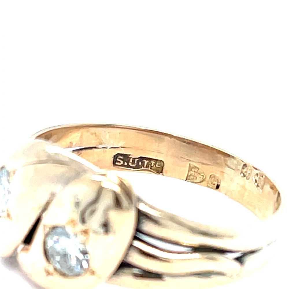 An antique yellow gold ring crafted with two entwined snake heads, each set with a round cut diamond. View III