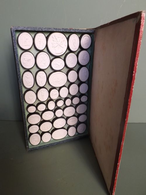 fig 1. Collection of C19th erotic 'Grand Tour' souvenir plaster intaglios in 'faux book' binding.