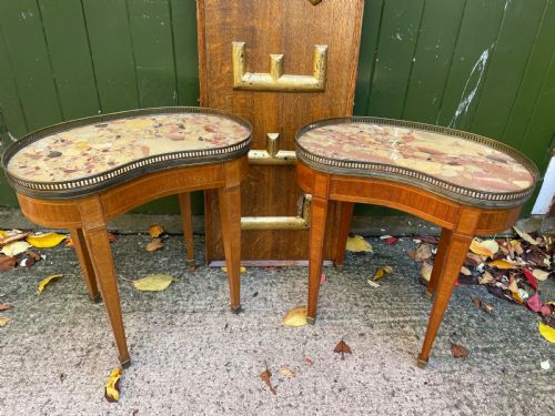 fig 1. A pair of early twentieth-century French kidney-shaped side tables made from walnut and kingwood with brass galleried marble tops and tapered legs.