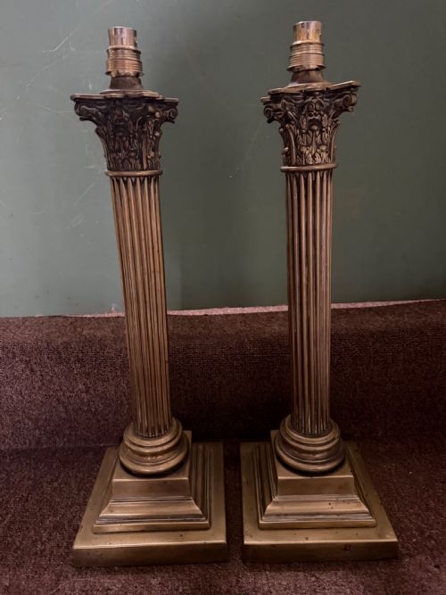 fig 1. A pair of 19th-century brass table lamps featuring fluted classical Corinthian columns set on stepped square plinths.
