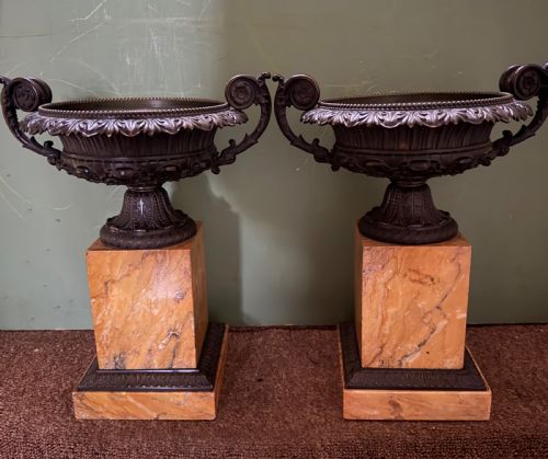 fig 1. A pair of early 19th-century French Charles X dark bronze tazze with scrolling handles set upon yellow Siena marble plinth bases.