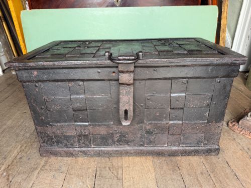 fig 1. A rectangular late seventeenth-century wrought iron strongbox with criss-crossing riveted bands and a heavy central iron locking hasp.