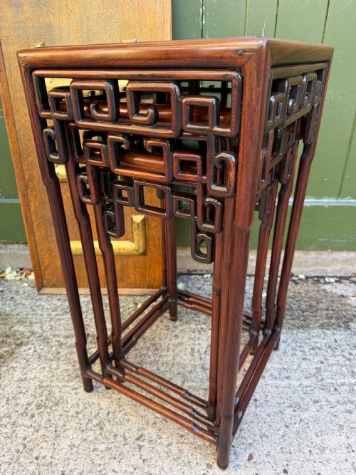 fig 1. A set of three graduated dark hardwood Chinese nesting tables featuring openwork carved fretwork aprons and straight legs with perimeter stretchers.