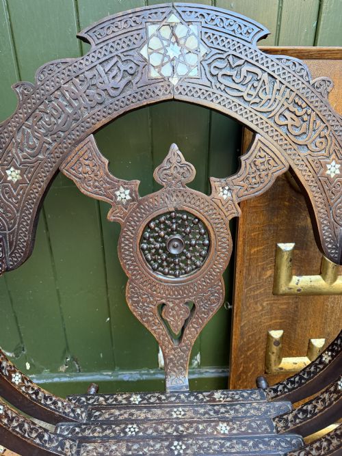 fig 2. A pair of late nineteenth-century Syrian armchairs crafted from dark carved wood with mother-of-pearl inlay, Arabic script panels, and curule x-frames.
