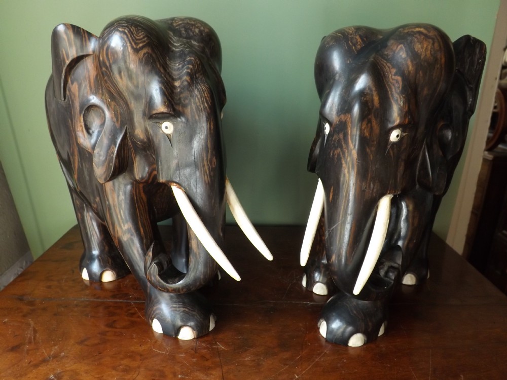 Pair of early C20th Indian carved coromandel elephants.