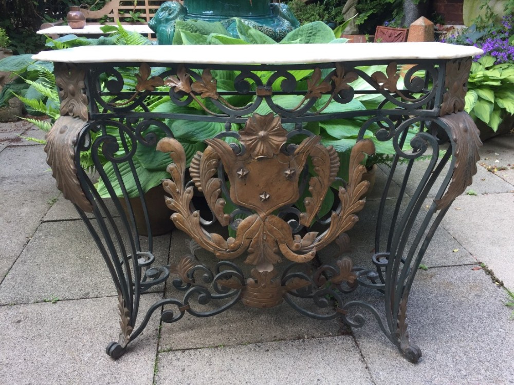 Early C20th French wrought iron and bronzed tole-mounted marble top console table.