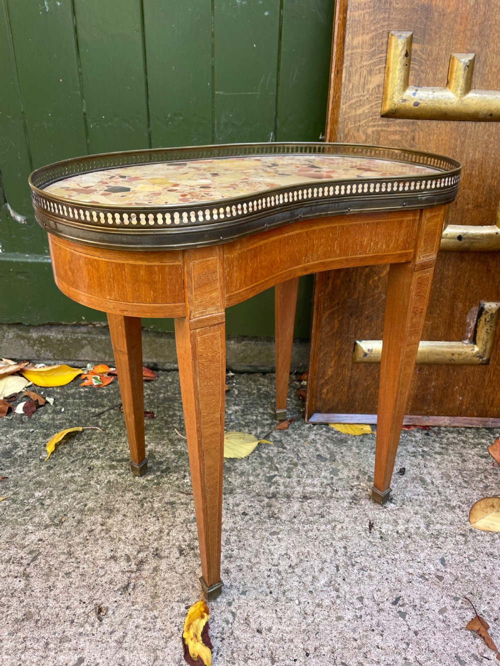 A pair of early twentieth-century French kidney-shaped side tables made from walnut and kingwood with brass galleried marble tops and tapered legs. View III
